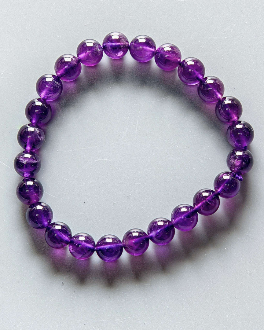 Purple beaded bracelet on a white background