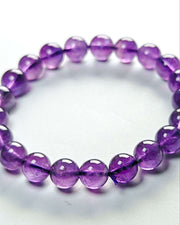 Purple beaded bracelet on a white background