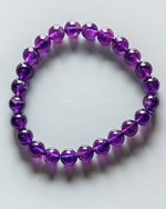 Load image into Gallery viewer, Purple beaded bracelet on a white background
