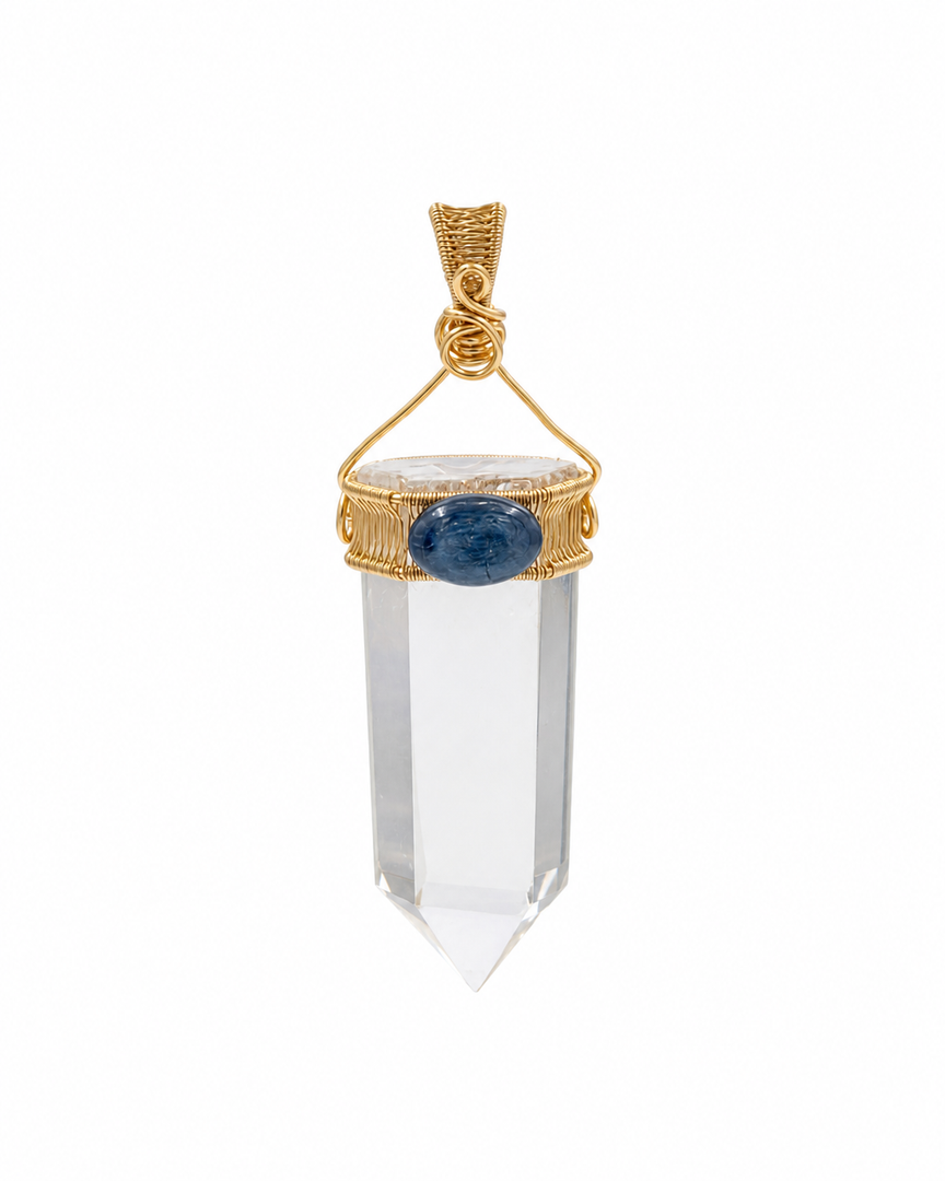 A clear crystal point pendant with a gold wire-wrapped setting and a central oval blue gemstone, shown on a plain white background.