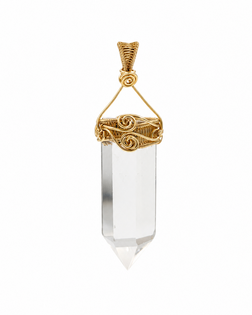 A clear crystal point pendant with an ornate gold wire-wrapped bail and top loop, shown against a plain white background.