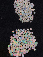 Load image into Gallery viewer, Opal stones with multicolor fluorescence on a black background
