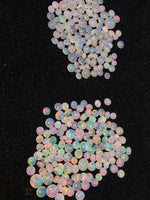 Load image into Gallery viewer, Opal stones with multicolor fluorescence on a black background
