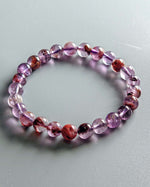 Load image into Gallery viewer, Multicolored beaded bracelet on a light gray background
