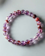 Load image into Gallery viewer, Purple beaded bracelet on a light gray background
