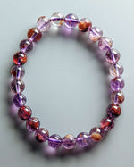 Load image into Gallery viewer, Multicolored beaded bracelet on a light gray background
