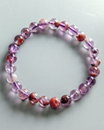 Load image into Gallery viewer, Beaded bracelet with pink and purple stones on a light gray background
