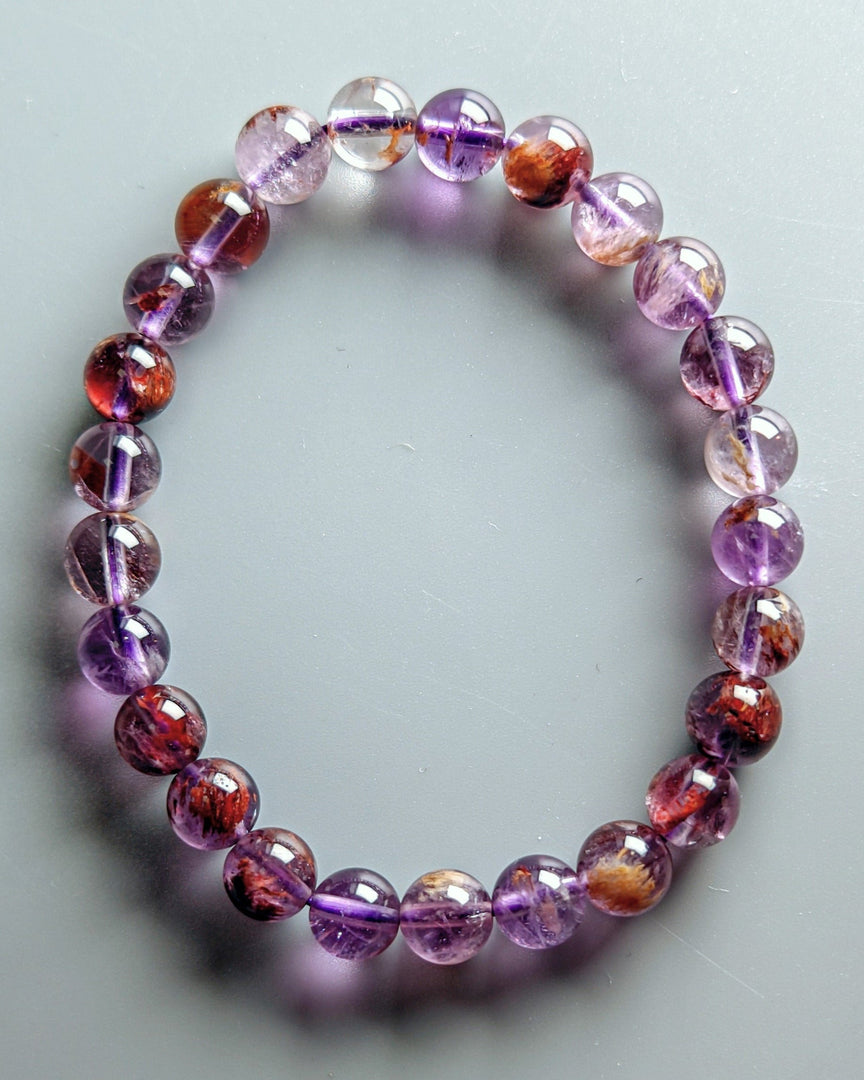 Multicolored beaded bracelet on a light gray background